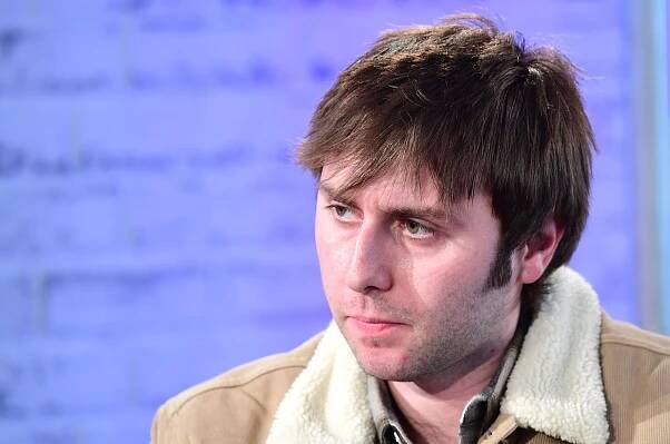 Headshot of James Buckley.
