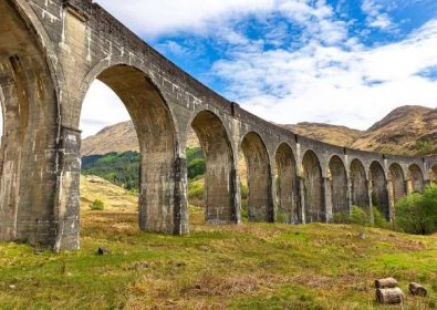 Glenfinnan Viaduct from underneath with a view of the arches curving round.