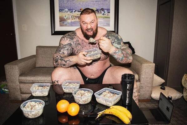 Hafthor Bjornsson eating a large meal.