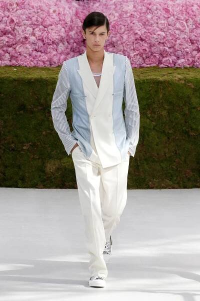 Image may contain Clothing Apparel Shirt Human Person Suit Coat Overcoat Long Sleeve and Sleeve