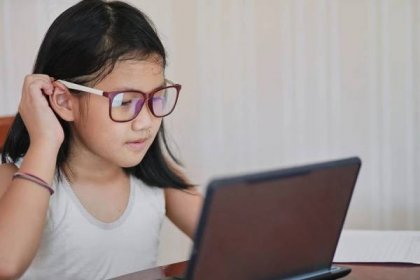 girl use a laptop for her homeschooling