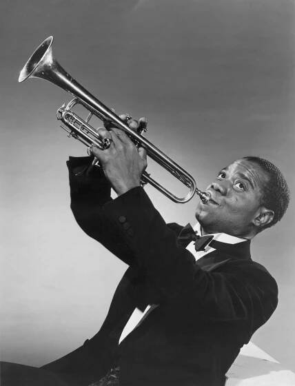 Louis Armstrong playing the trumpet as a young adult