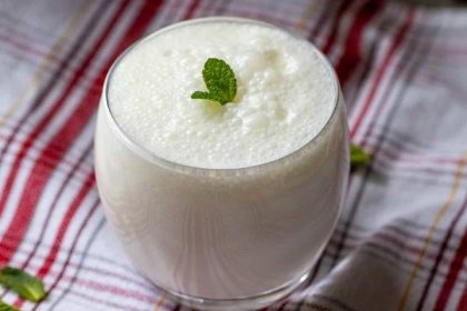 ayran - turkish yogurt drink is served in a glass with mint leaves
