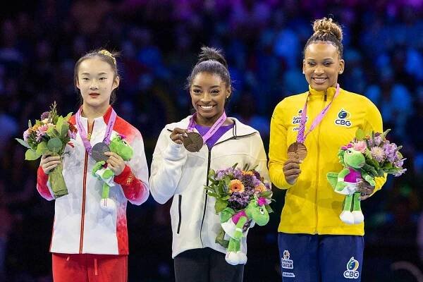Gold medal winner Simone Biles of the United States on the podium with silver medalist Yaqin Zhou of China and bronze medalist Rebeca Andrade of Brazil after the Women's Balance Beam Final at the Artistic Gymnastics World Championships-Antwerp 2023 