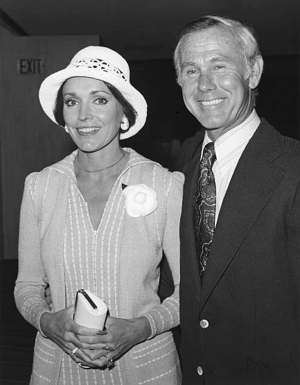 Black and white photo of Johnny Carson with a woman.