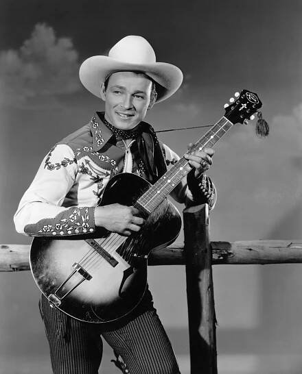 Roy Rogers playing an acoustic guitar.