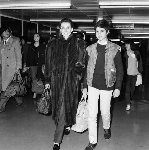 A woman in a fur coat with her teen son in 1984