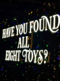 light sign that reads 'Have you found all eight toys?' 