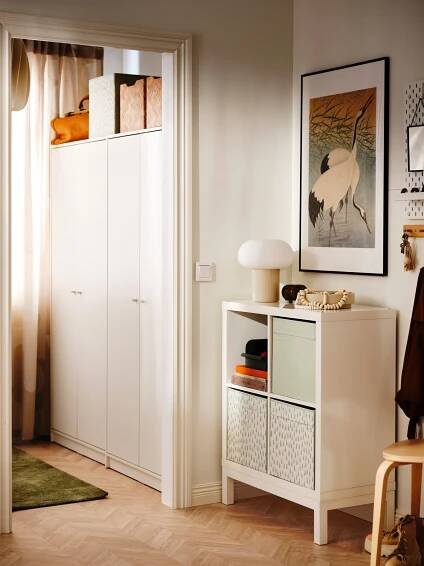 A beige/opal white glass DEJSA table lamp in the bedroom
