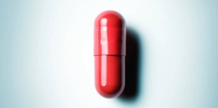 Close up of a red pill