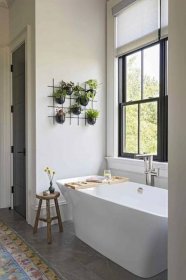 white bathroom with plants hanging on the wall
