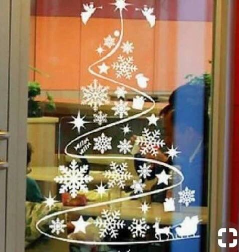 a christmas tree made out of snowflakes is seen through a window with the words happy new year written on it