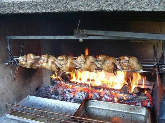 a row of meat cooking on a grill at Pension Helene s mini pivovarem in Kytlice