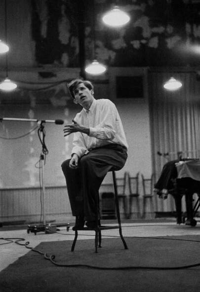A shoeless Glenn Gould listened to playback of his Bach performance at a Columbia recording studio; he would decide that he needed to do this section over, 1956.