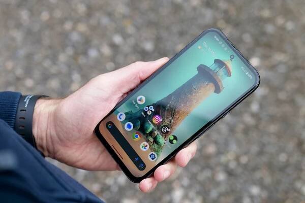 A person holding the Google Pixel 8a, showing the screen.