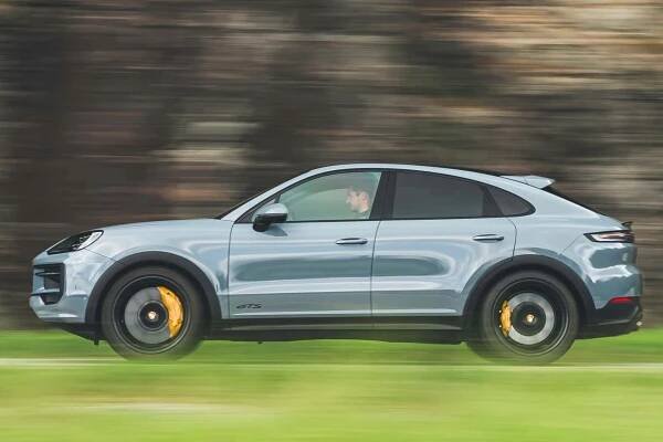 Side view of a 2024 gray Porsche Cayenne GTS Coupe