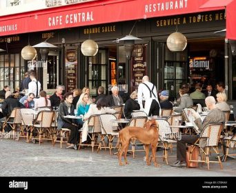 People having lunch outside Cafe Central on Rue Cler, in the Invalides quartier of Paris. Editorial use only. Stock Photo