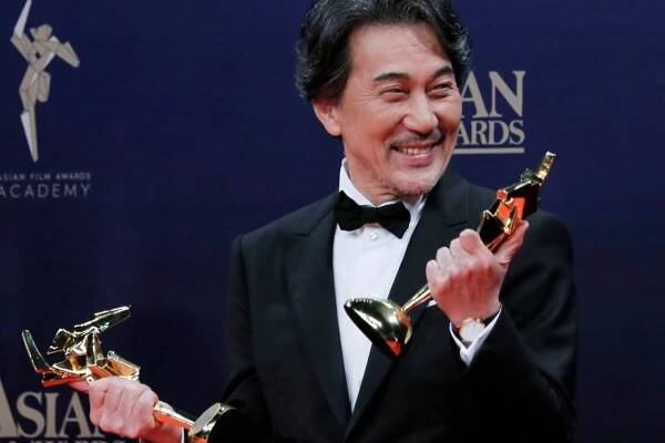Japanese actor Koji Yakusho poses after winning the Best Actor and Excellence in Asian Cinema Award of the Asian Film Awards in Hong KongAsian Film Awards, Hong Kong, Hong Kong - 17 Mar 2019