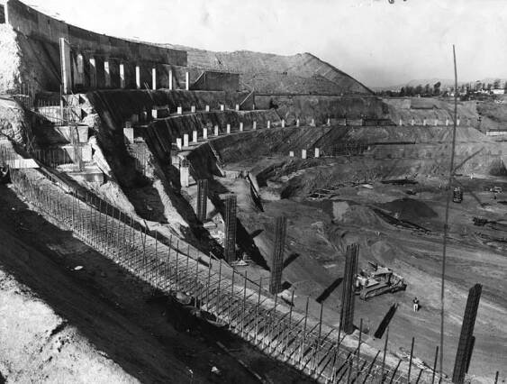 A stadium starts to take shape in a construction zone with layers of eventual seating visible.