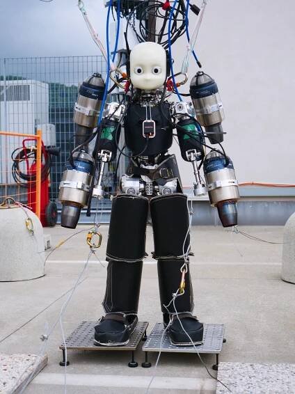 The iRonCub3 prototype tethered to its evaluation rig at the Artificial and Mechanical Intelligence group's lab