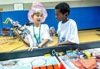 Samuel Snowden, 9, left, who is homeschooled and claims to have been born with a Lego in his hand, talks strategy with teammate Samson Scheie, 12, also homeschooled, before running their robot in the First Lego League competition at DoD's Starbase building near the Air Force Research Laboratory at Wright Patterson Air Force Base in Dayton, Ohio, Jul 22, 2016. The Air Force STEM outreach offices work with the First Lego League, which teaches young students how to build and program robots made of Legos, to not only support STEM education, but also to make young technical minds aware of opportunities to pursue science in the U.S. Air Force. (U.S. Air Force photo by J.M. Eddins Jr.)