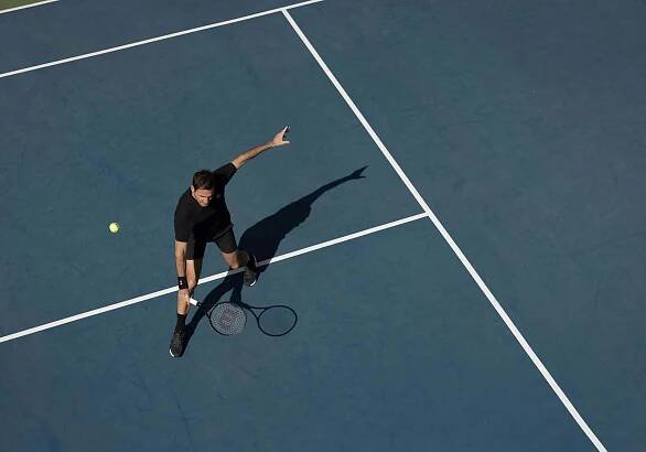Roger Federer on court with RF Collection racket.