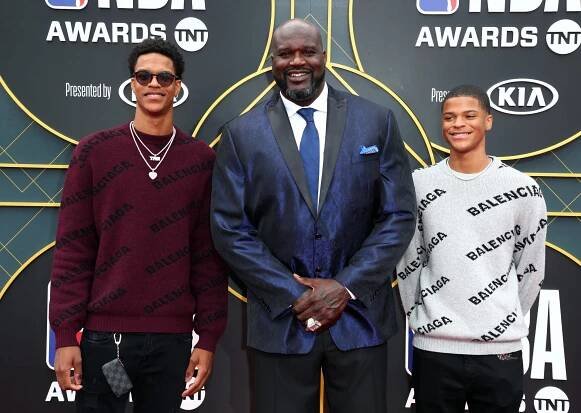 Shaquille O'Neal posing with his sons Shaqir O'Neal and Shareef O'Neal.