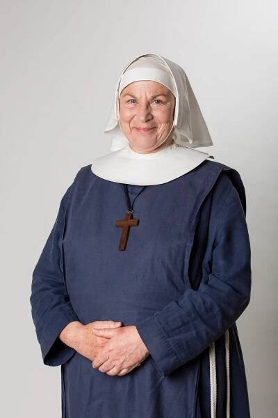 Portrait of Sister Evangelina (Pam Ferris) wearing a nun's habit and a cross necklace.