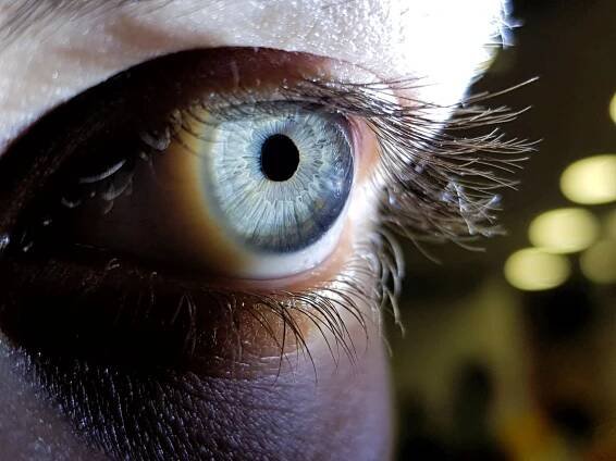 Close up photo of an eye under a light.