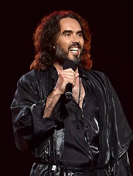 LOS ANGELES, CALIFORNIA - JANUARY 24: Russell Brand speaks onstage during MusiCares Person of the Year honoring Aerosmith at West Hall at Los Angeles Convention Center on January 24, 2020 in Los Angeles, California. (Photo by Lester Cohen/Getty Images for The Recording Academy )
