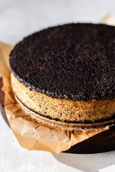 Oreo cheesecake second crust pressed on top of baked cheesecake