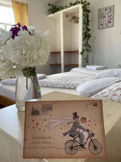 a sign on a table with a vase of flowers at Penzion Slunečnice in Dvůr Králové nad Labem