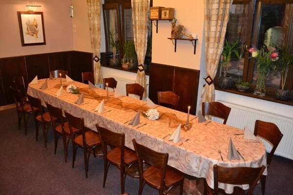 a long table in a room with chairs at Penzion Aladdin in Teplice