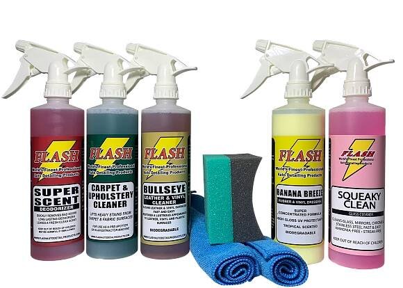 A set of automotive cleaning products with spray bottles and towels.