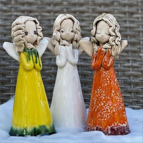 three ceramic figurines are standing in the snow