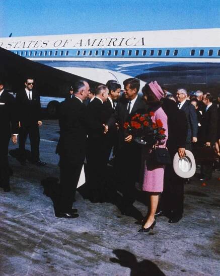 US President John F Kennedy, First Lady Jacqueline Kennedy, carrying a bouquet of red roses, move down reception line, November 22nd,
