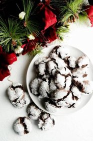 A plate of chocolate crinkles with holiday garland.