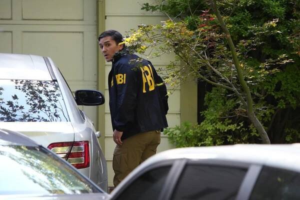 FBI agent at John Bolton's home.