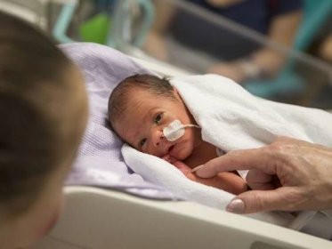 Baby in hospital looking at mum