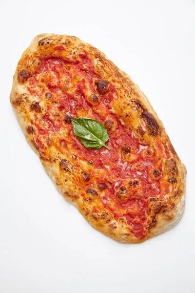 A pizza with tomato sauce and basil on it