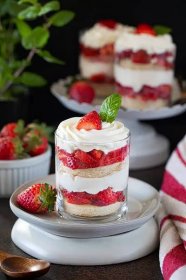 Strawberry and cream trifle cups garnished with strawberries and mint leaves