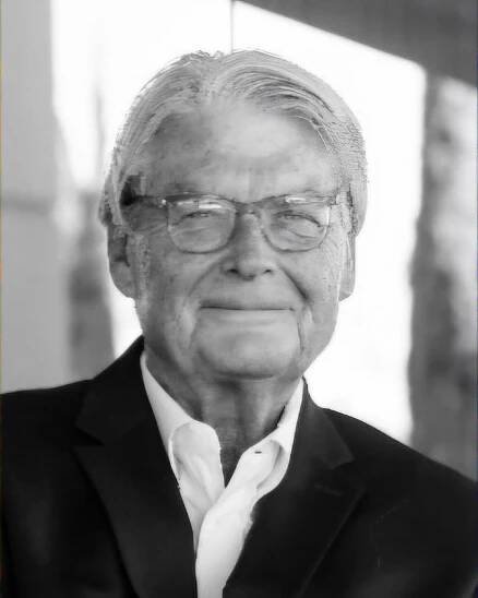 a man in a suit with glasses