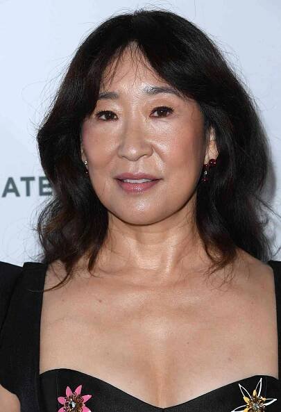 Sandra Oh with a medium length haircut with curtain bangs
