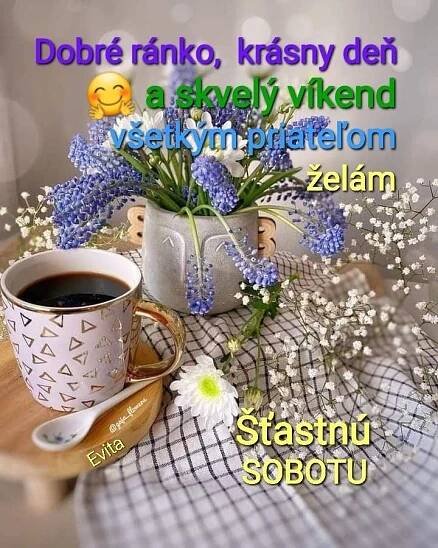 a cup of coffee sitting on top of a table next to a vase filled with flowers