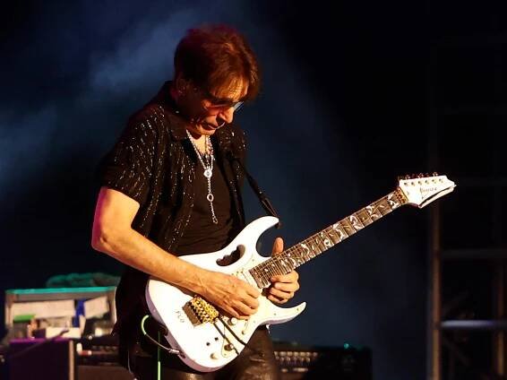 Steve Vai playing guitar with the Satchvai band.