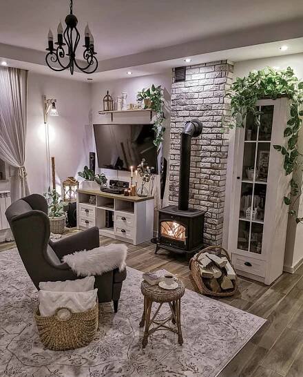 a living room filled with furniture and a fire place next to a tv mounted on a wall