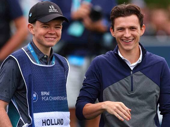 Tom Holland (R) smiles alongside his brother and caddie, Paddy Holland during the Pro-Am prior to the BMW PGA Championship at Wentworth Golf Club on September 13, 2023