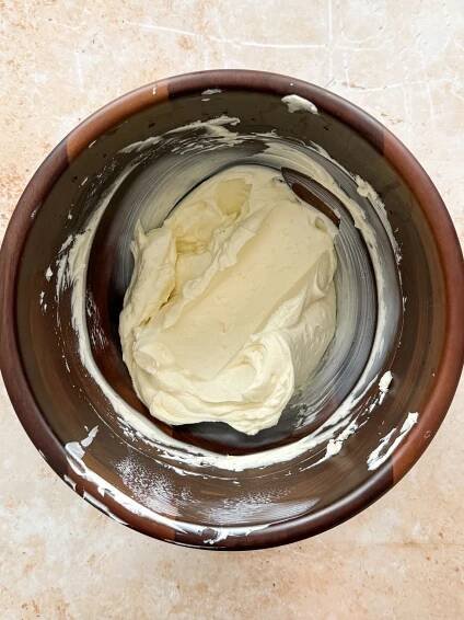 cream cheese, sugar and vanilla in a wooden bowl whisked tigether until creamy
