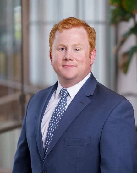 Portrait of Christopher Whelen, attorney at Huber Thomas Law, dressed professionally, representing his role and expertise on the legal team.