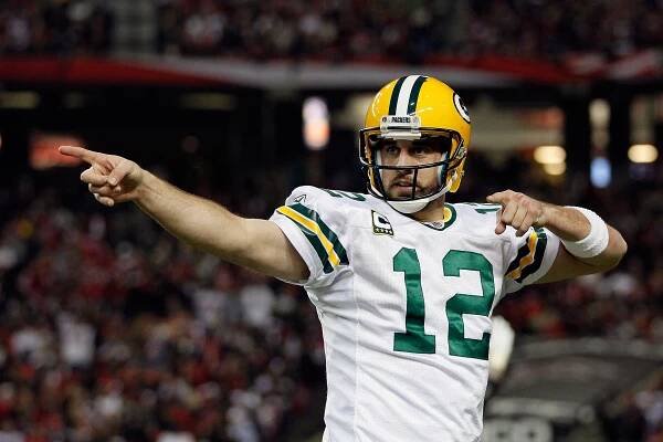 Aaron Rodgers #12 of the Green Bay Packers reacts after he threw a 7-yard touchdown to John Kuhn #30 in the third quarter against the Atlanta Falcons during their 2011 NFC divisional playoff game at Georgia Dome on January 15, 2011 in Atlanta, Georgia. 
